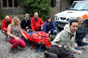 HSBC staff learn how to load and move a stretcher with members of ASSAR.